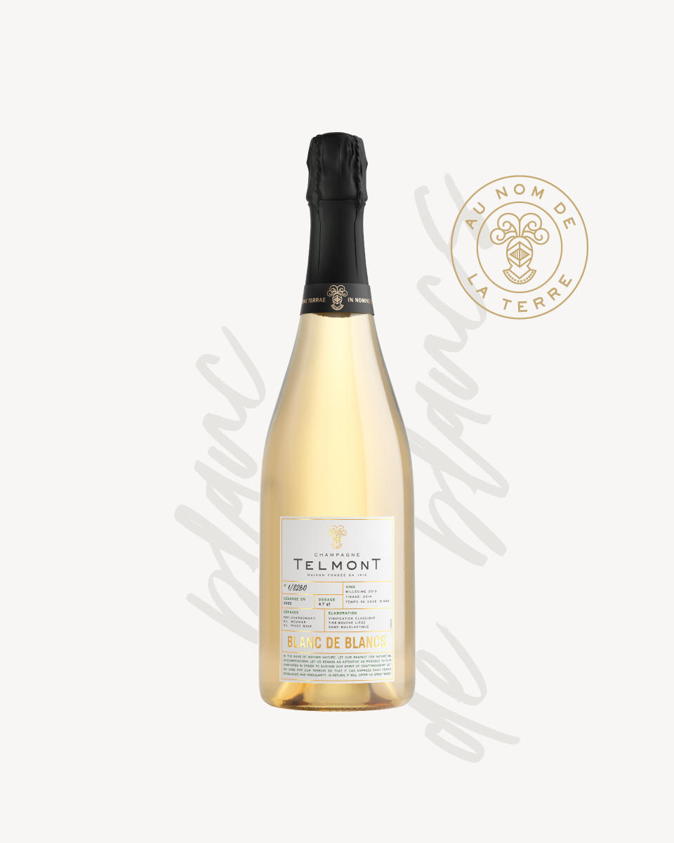 Open image in slideshow, A packshot of a bottle of Champagne Telmont Blanc de Blancs, text in the background, Telmont stamp on the right